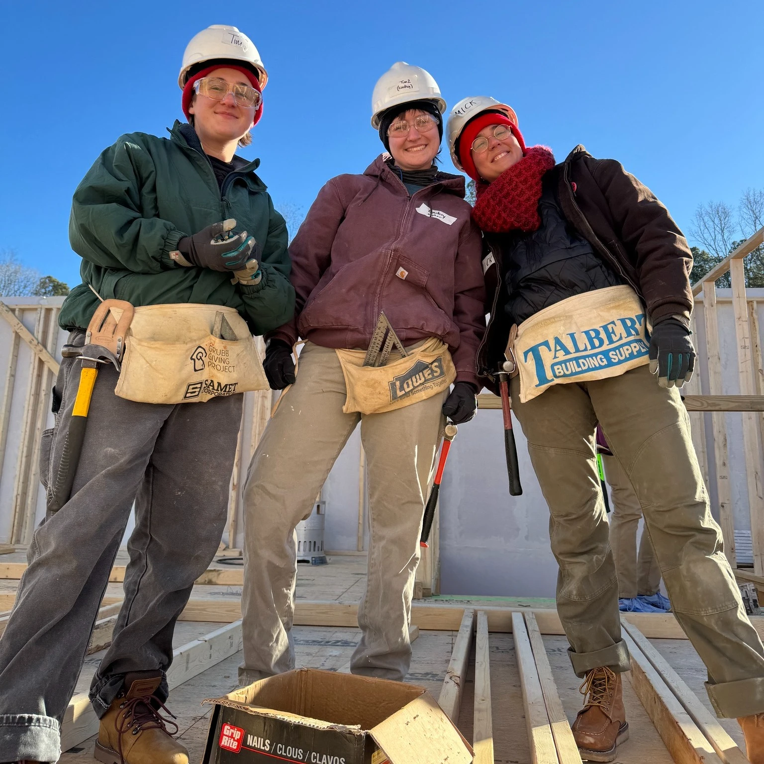 Three Hope Renovations trainees on a build site
