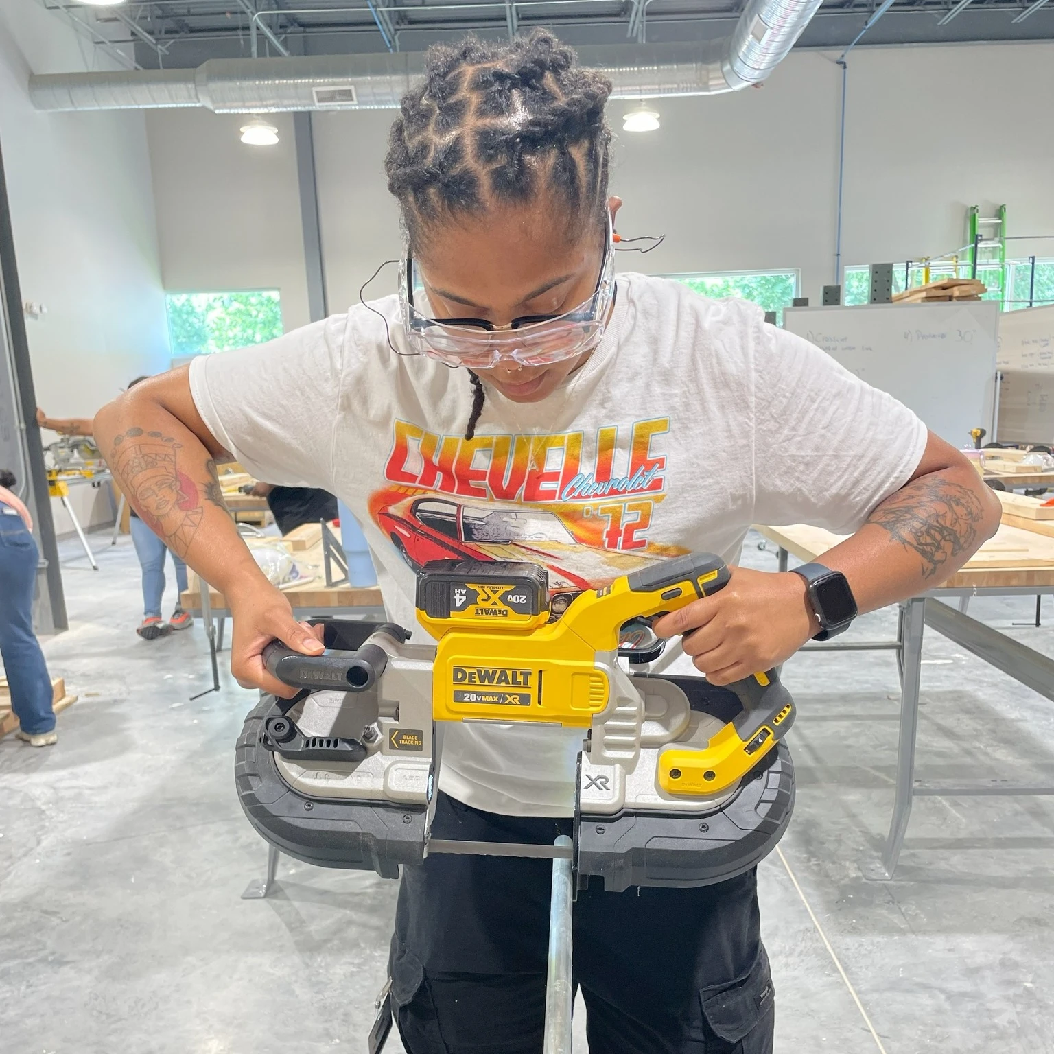 A trainee learning to use a band saw